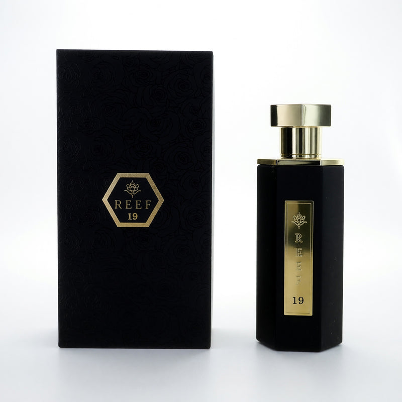 Reef 19 by Reef Perfumes 3.4 oz men's parfum spray, elegant bottle with sleek design and silver accents.