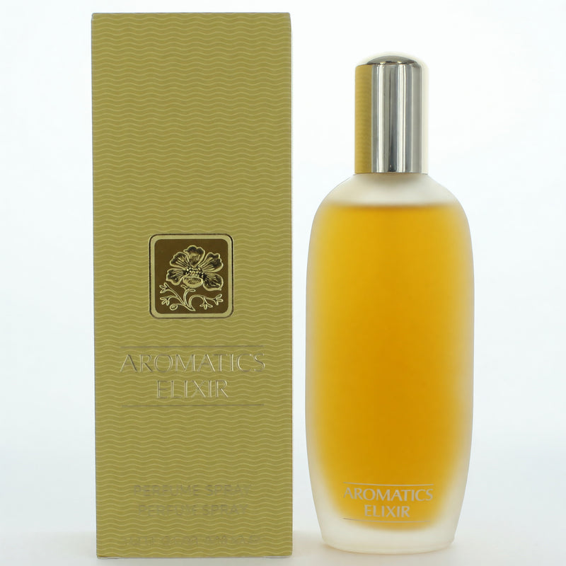 A woman holding a 3.4 oz bottle of Aromatics Elixir by Clinique perfume spray for women with elegant packaging.