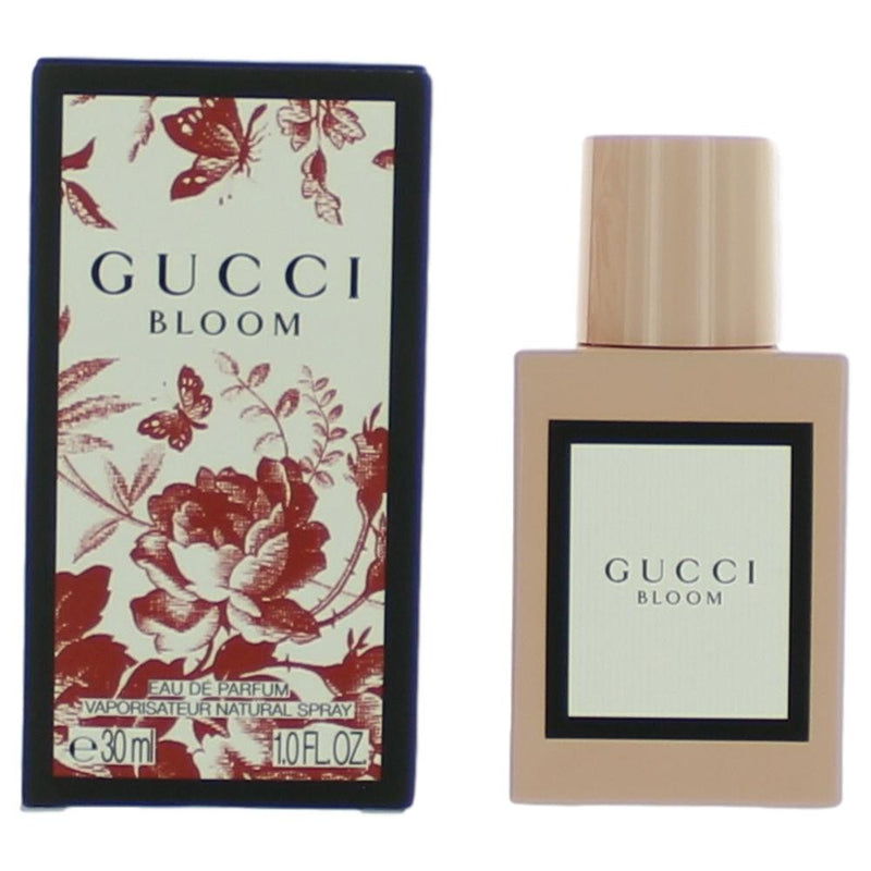 Gucci Bloom by Gucci 1 oz women’s Eau de Parfum spray, featuring a clear glass bottle with floral design and gold accents.