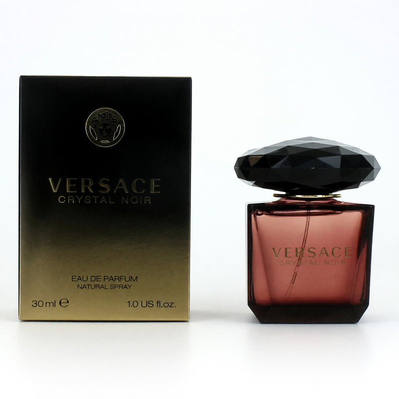 Versace Crystal Noir 1 oz EDP spray for women, elegant clear glass bottle with black cap, showcasing the luxurious fragrance.