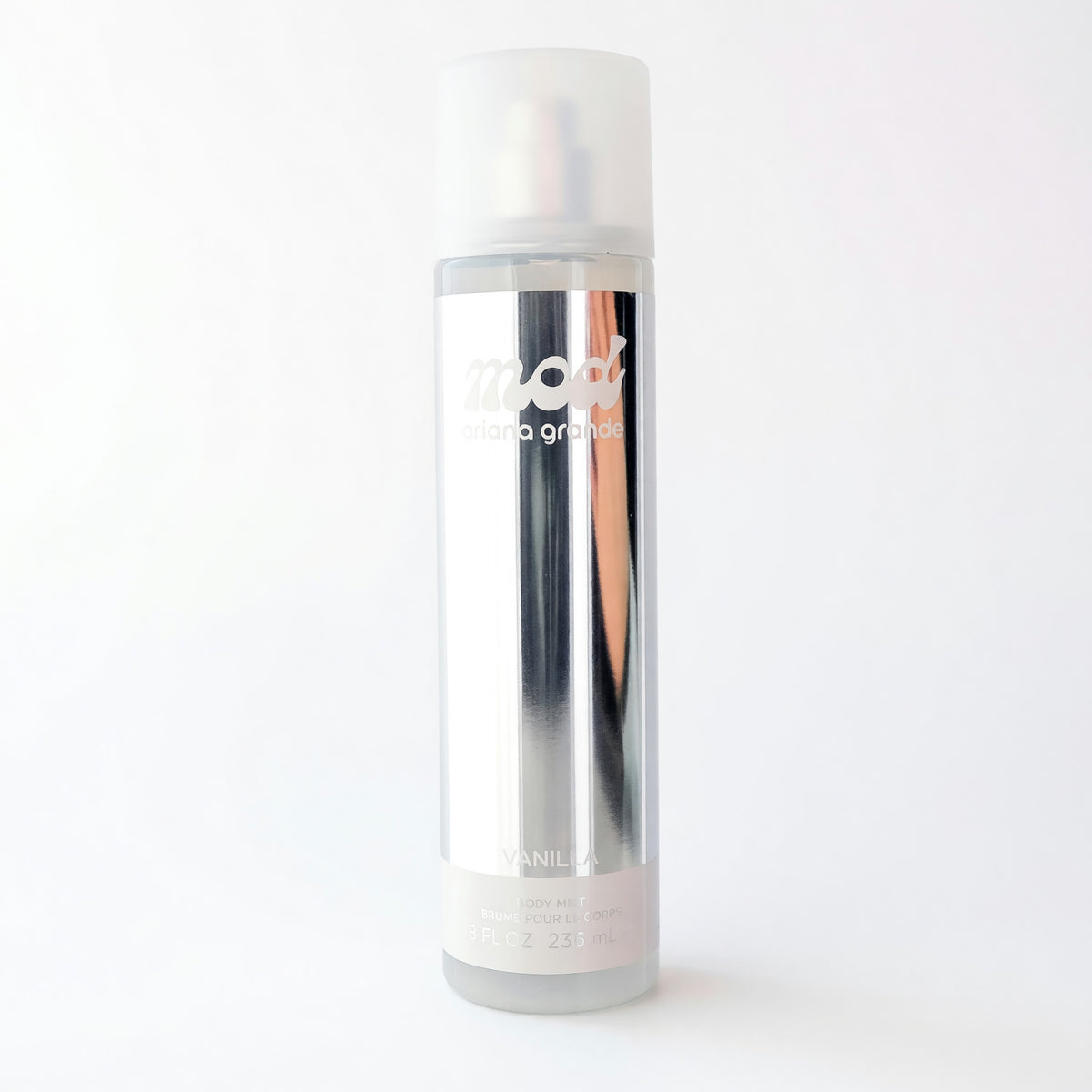 Ariana Grande MOD Vanilla body mist for women, 8 oz bottle with a sleek design, featuring a clear container and white cap.