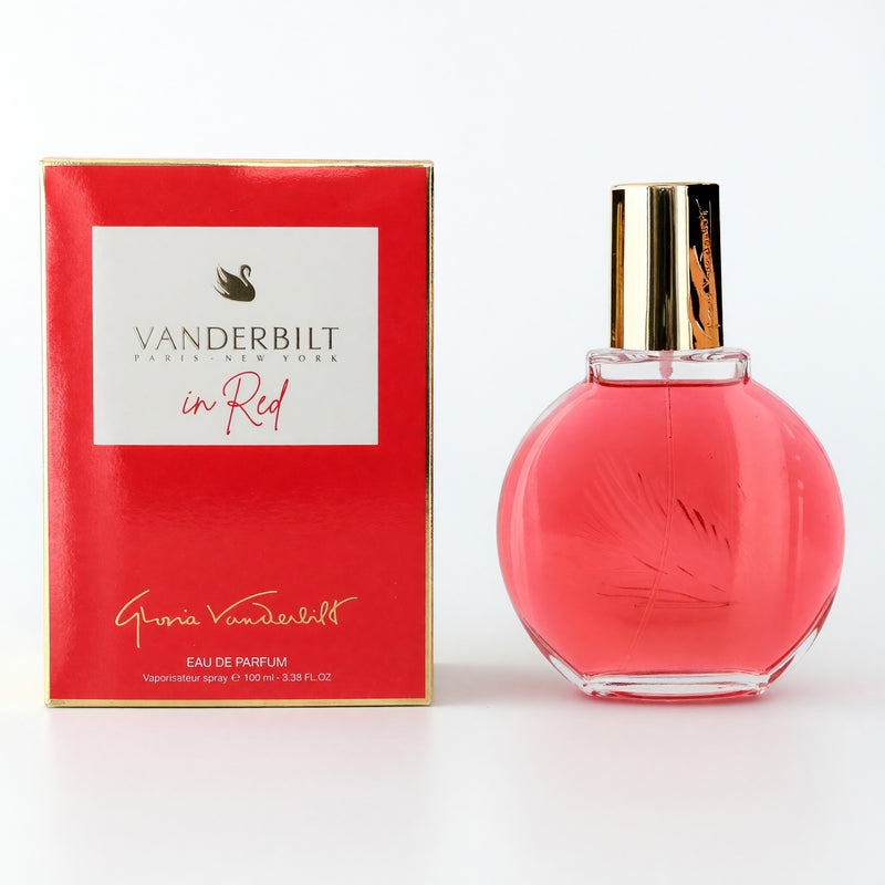 Gloria Vanderbilt Vanderbilt Red 3.3 oz EDP spray for women, elegant perfume bottle with red accents on a reflective surface.
