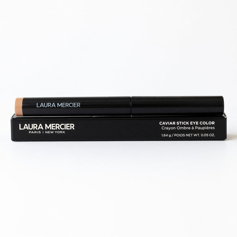 Laura Mercier Caviar Stick Eye Color in Moonlight, a shimmering eyeshadow stick, shown with the product tube and swatched on skin.