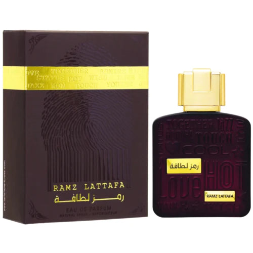 Lattafa Ramz Gold Eau De Parfum 3.4oz unisex bottle by Pertinacia Perfume, elegant gold packaging and clear glass design.